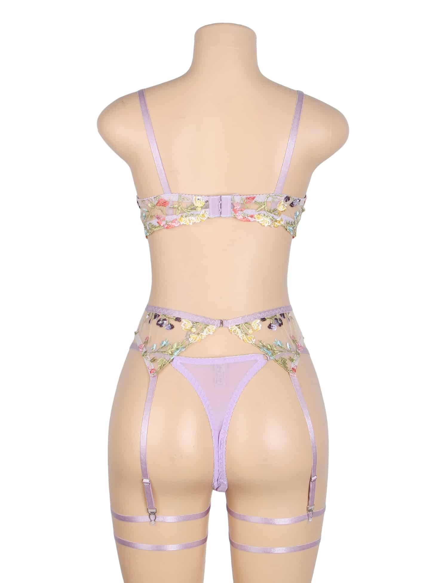 Back view of purple floral lingerie set with adjustable hook closure, sheer mesh briefs, garters, and leg loops