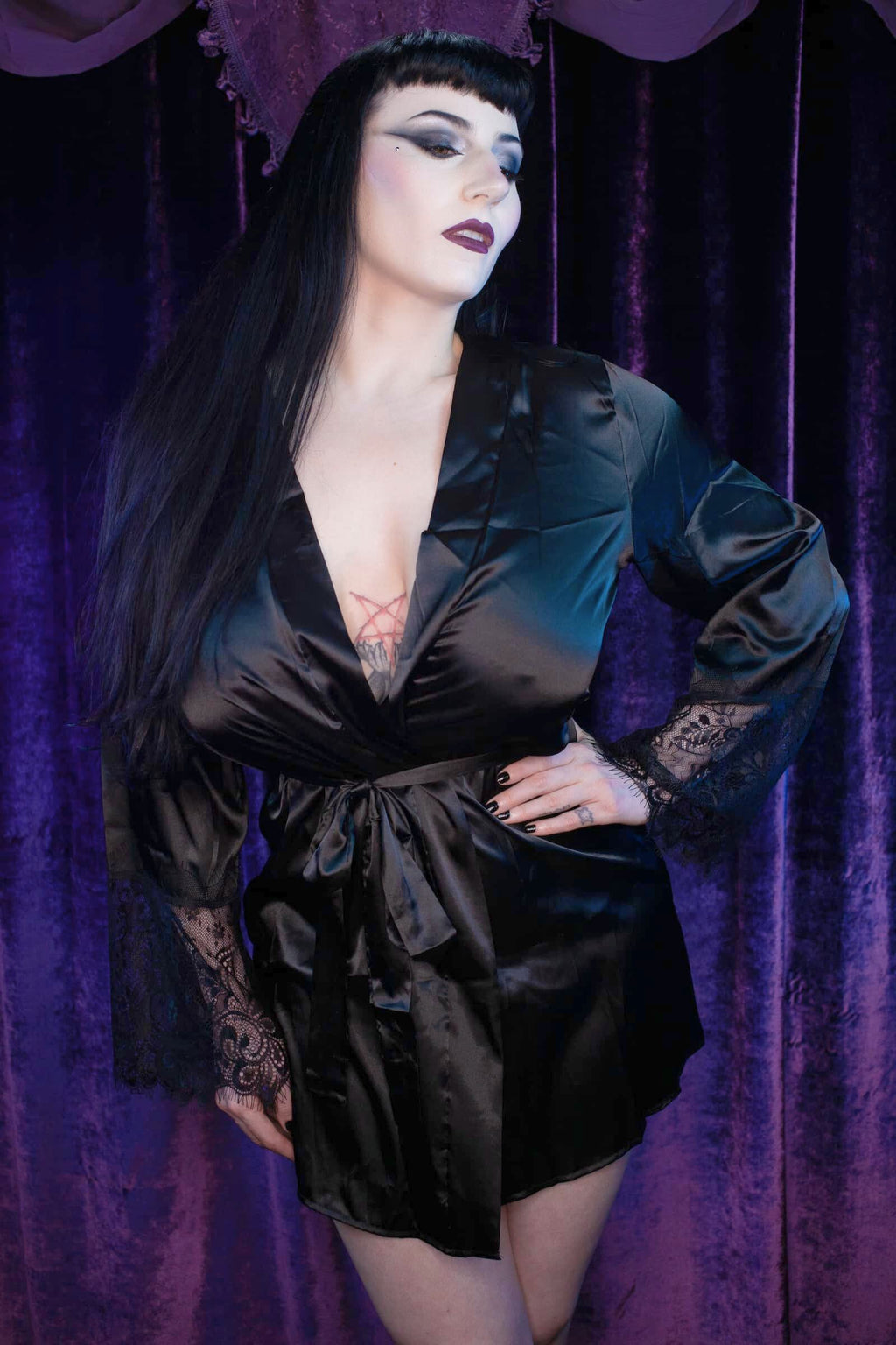 Model wearing Dahlia, a sexy black satin robe with black lace detailing on the cuffs
