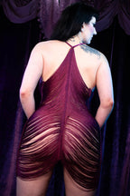 Model wearing Desiree, a burgundy tassel stripper dress that accents the booty immeasurably
